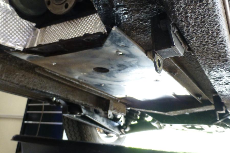 What is the hole in the heat shield above the mufflers for? EType